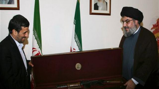 Mahmoud Ahmadinejad menerima cenderamata senapan serbu dari pemimpin Hisbullah