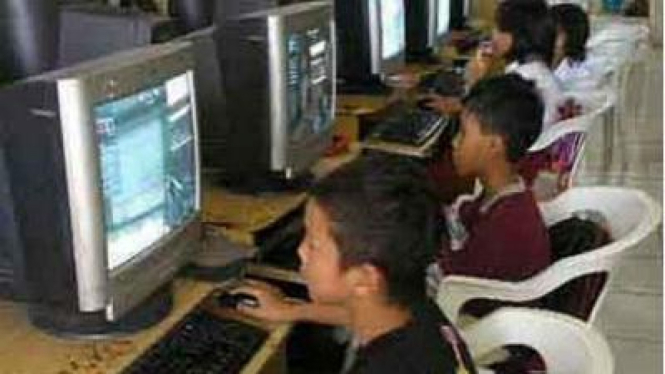 Anak-anak bermain game online di PC.