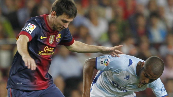 Lionel Messi (kiri) saat menghadapi Getafe