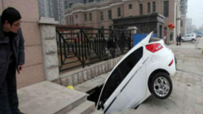 Mobil terperosok lubang di China