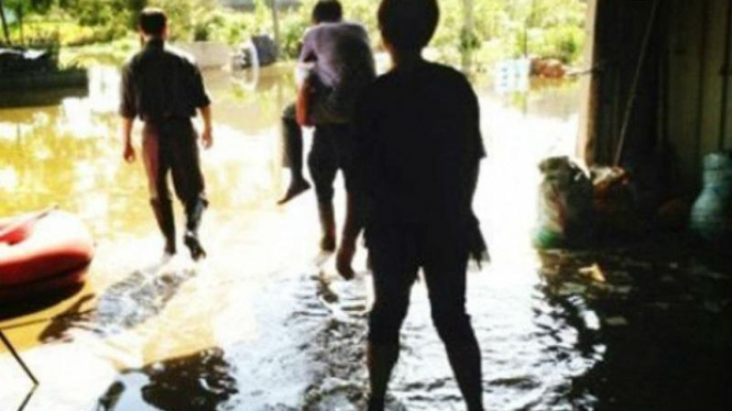 Pejabat di China digendong saat mengunjungi korban banjir