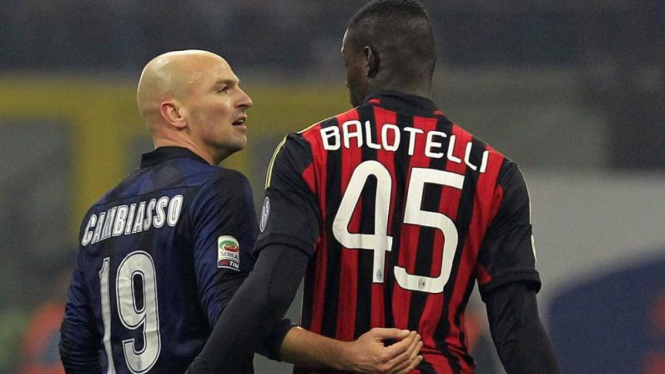 Mario Balotelli bicara dengan Esteban Cambiasso dalam derby Milan