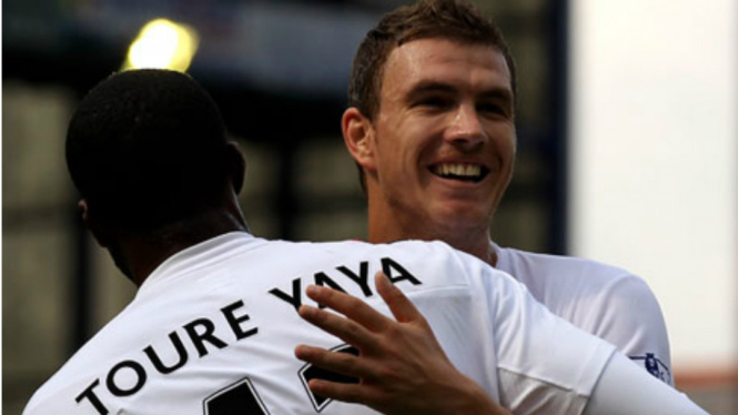 Edin Dzeko merayakan gol bersama Yaya Toure