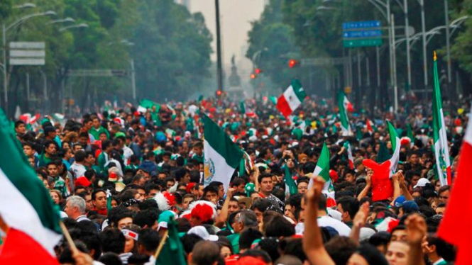 Suporter Meksiko merayakan lolos ke 16 besar Piala Dunia 2014