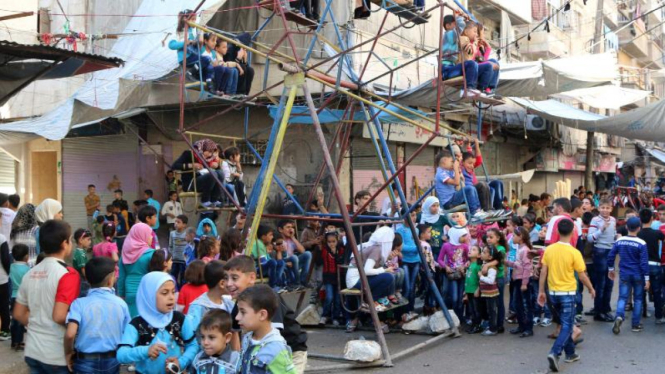 Anak-anak bermain di Aleppo, Suriah, saat perayaan Idul Adha, 4 Oktober.