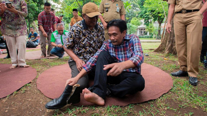 Wagub DKI Jakarta Djarot Syaiful Hidayat bersiap pakai sepatu. 