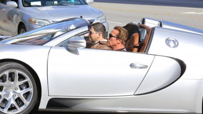 Arnold Schwarzeneger sedang menyetir Bugatti Veyron