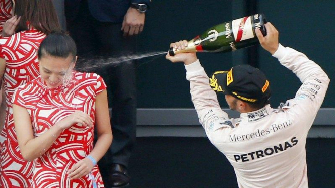 Lewis Hamilton saat menyemprot wajah salah satu grid girl