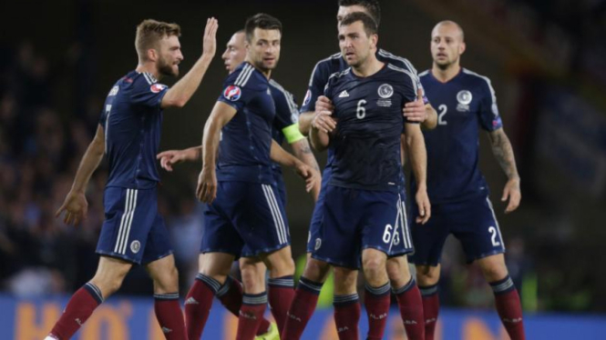 Pemain Skotlandia merayakan gol ke gawang Jerman, Selasa, 8 September 2015.