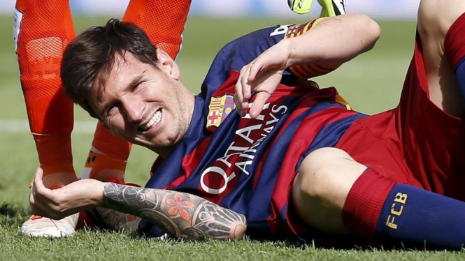 Pemain Barcelona, Lionel Messi, meringis kesakitan