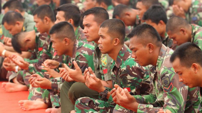 Prajurit TNI salat sebelum bertugas padamkan api kebakaran hutan.