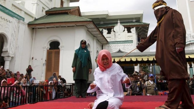 Warga Aceh yang melanggar saat dihukum cambuk dengan rotan. (Ilustrasi)