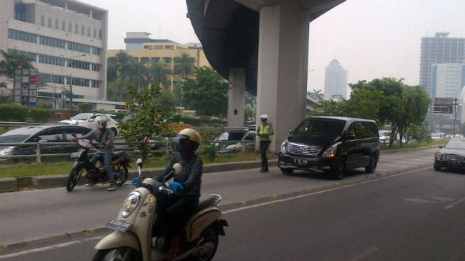 Petugas memberi sanksi tilang ke pengendara mobil yang masuk jalur TransJakarta.