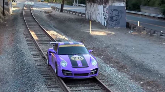 Porsche 911 Turbo dicoba di atas rel kereta api.