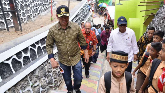 Menteri Pekerjaan Umum dan Perumahan Rakyat, Basuki Hadimuljono (berkemeja putih), dan Wali Kota Malang, Mochamad Anton, saat mengunjungi Kampung Warna-warni pada Jumat, 23 September 2016.