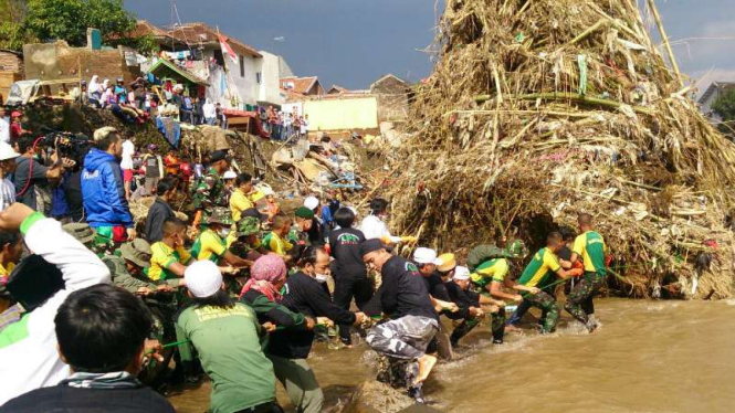 Aparat TNI bersama warga mencari korban banjir bandang di bawah jembatan rel kereta api di Desa Jayawaras, Kecamatan Tarogong Kidul, Kabupaten Garut, Jawa Barat, pada Jumat, 30 September 2016.