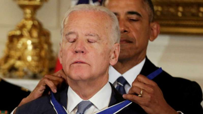 Presiden AS, Barack Obama, mengalungkan medali kehormatan untuk Wakil Presiden Joe Biden.