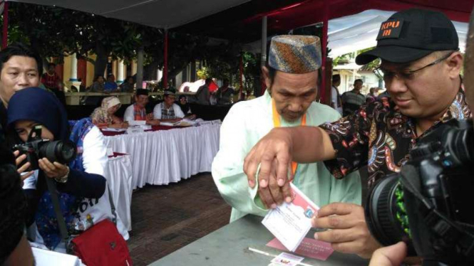Ketua KPU, Arief Budiman (kanan), melakukan simulasi pemungutan suara.