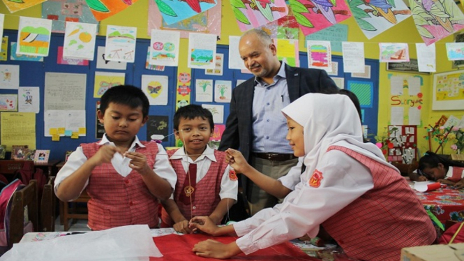 Paul Weisenfeld melihat siswa kelas IV yang sedang membuat layang-layang.