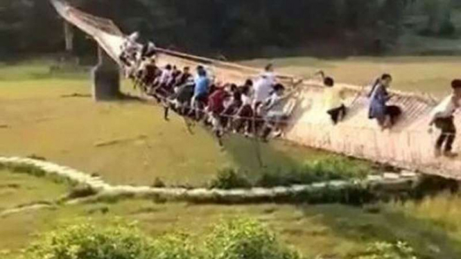 Puluhan turis China mati-matian bertahan agar tak terjatuh dari jembatan.