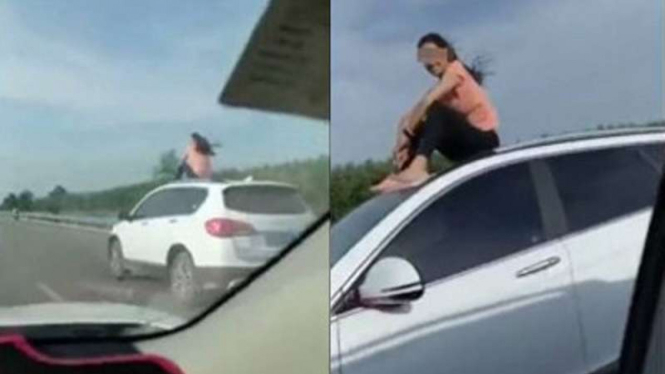 Aksi nekat perempuan naik di atap mobil.