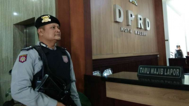 Polisi bersenjata menjaga akses masuk lantai dua gedung DPRD Kota Malang saat tim KPK menggeledah kantor itu pada Kamis, 10 Agustus 2017. 