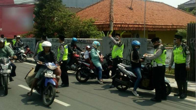 Polisi berpeci saat gelar razia di Kota Depok, Jawa Barat.