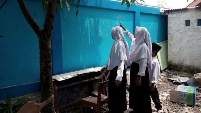 Novia menunjukan tembok tempat murid SMPN Kosambi menyelamatkan diri.