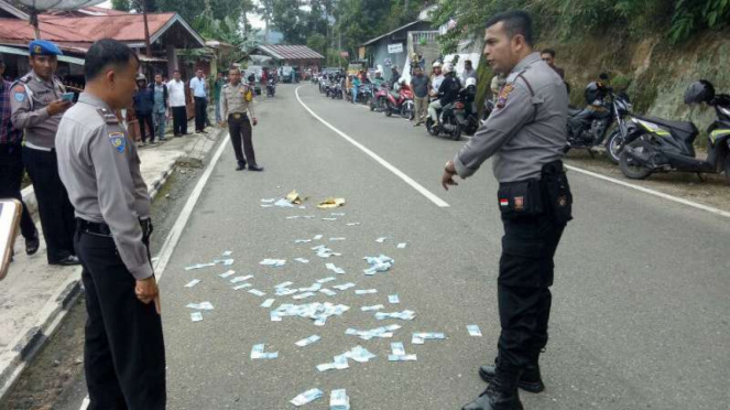 Uang hasil rampokan yang disebar pelaku di Kota Sawahlunto, Sumatera Barat.