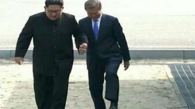 Pemimpin Korea Utara Kim Jong Un dan Presiden Korea Selatan Moon Jae In melangkah ke wilayah Korsel.
