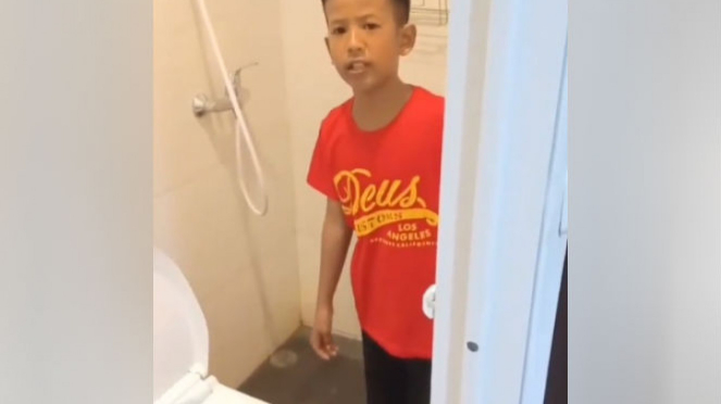 Bocah cuci muka di pancuran toilet.