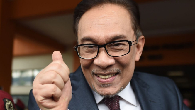 Anwar Ibrahim tampak menyambut para pendukung di hari pembebasannya dari penjara, Rabu (16/05). - MOHD RASFAN/AFP