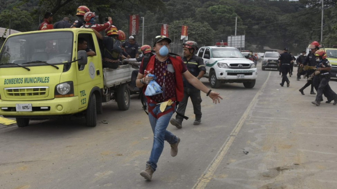 Relawan dan petugas keluar dari zona bencana Gunung Fuego. - AFP