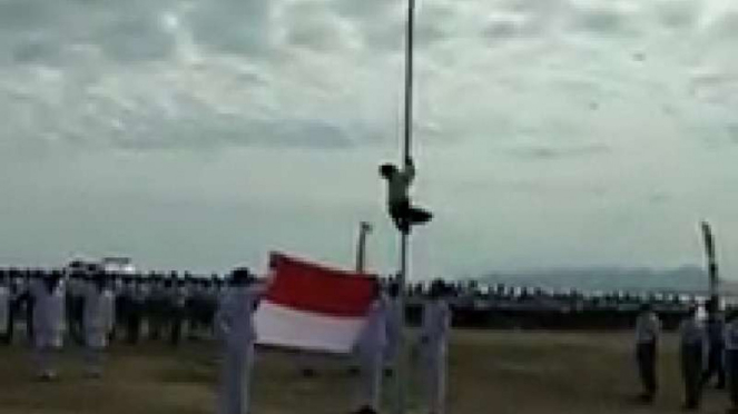 Seorang bocah memanjat tiang bendera dalam upacara di NTT