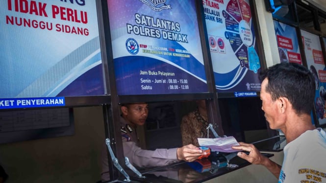 Pelanggar lalu lintas (lalin) mengurus surat tilang elektronik (e-tilang) di loket pelayanan tilang Polres Demak, di Demak, Jawa Tengah