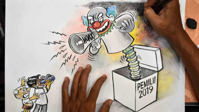 Seorang kartunis melukis kartun bertema Pengawasan Pemilu Partisipatif saat aksi