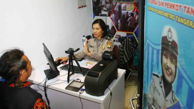 Petugas dari Satuan Penyelenggara Administrasi SIM (Satpas) Polres Metropolitan Tangerang melakukan perekaman data pemohon SIM di Mal Pelayanan Kantor Pemerintahan Kota Tangerang, Tangerang, Banten