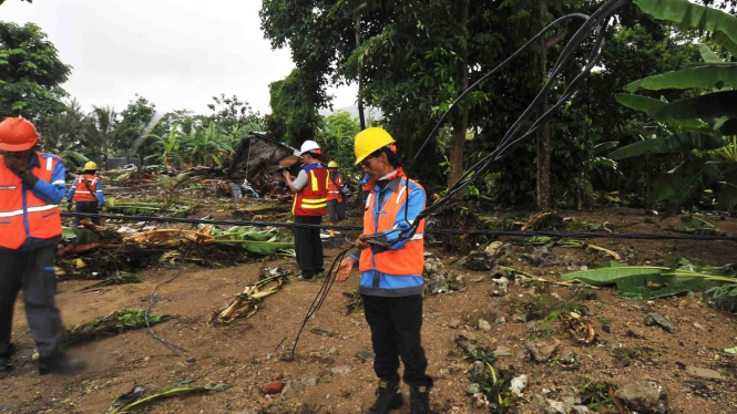 Sejumlah pekerja PT PLN membetulkan kabel jaringan listrik yang terputus akibat dihantam gelombang tsunami di Kawasan Wisata Carita, Pandeglang, Banten