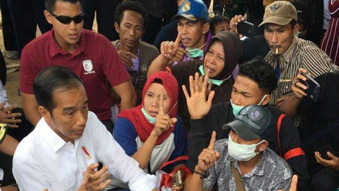 Pria merokok di samping Presiden Jokowi
