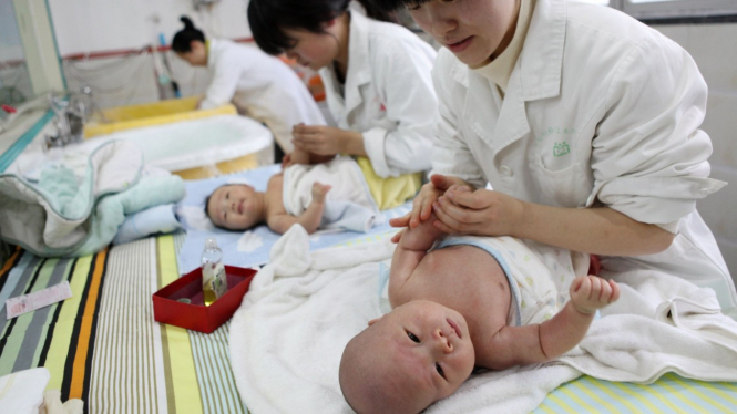 Para suster di rumah sakit saat merawat bayi.-AFP/Getty