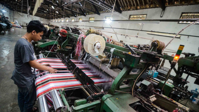 Pekerja menyelesaikan produksi kain sarung di Pabrik Tekstil Kawasan Industri Majalaya, Kabupaten Bandung, Jawa Barat, Jumat, 4 januari 2019.