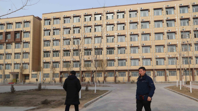 Kepala Kamp Pendidikan Vokasi Etnis Uighur Kota Kashgar,  Daerah Otonomi Xinjiang, Cina, Mijiti Meimeit (kanan) memandu wartawan yang berkunjung, Jumat, 3 Januari 2019.