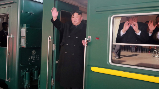 Kim Jong-un melambaikan tangan dari kereta ikoniknya, saat meninggalkan Pyongyang menuju Hanoi. Foto ini dirilis kantor berita KCNA pada tanggal 23 Februari. - Reuters