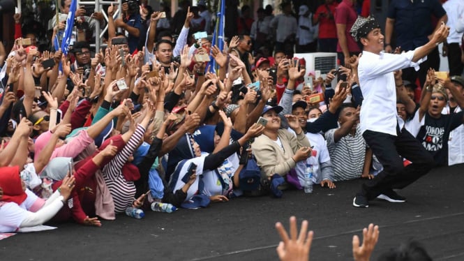 Calon Presiden petahana nomor urut 01 Joko Widodo berswafoto dengan pendukung saat kampanye terbuka di Banyuwangi, Jawa Timur, Senin, 25 Maret 2019.