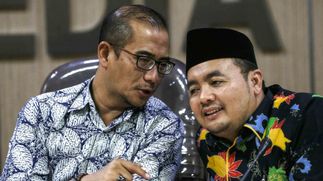 Komisioner Bawaslu Muhammad Afifudin (kanan) berbincang dengan Komisioner KPU Hasyim Asyari (kiri) saat konferensi pers terkait dugaan surat suara tercoblos di Malaysia di Jakarta,