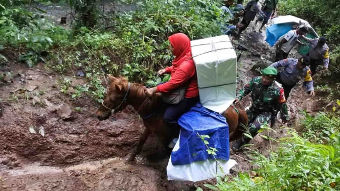 Personel TNI dan Polri mengawal distribusi logistik Pemilu serentak 2019 ke kawasan Taman Nasional Meru Betiri Dusun Bandealit, Desa Andongrejo, Tempurejo, Jember, Jawa Timur, Senin ,15 April 2019.