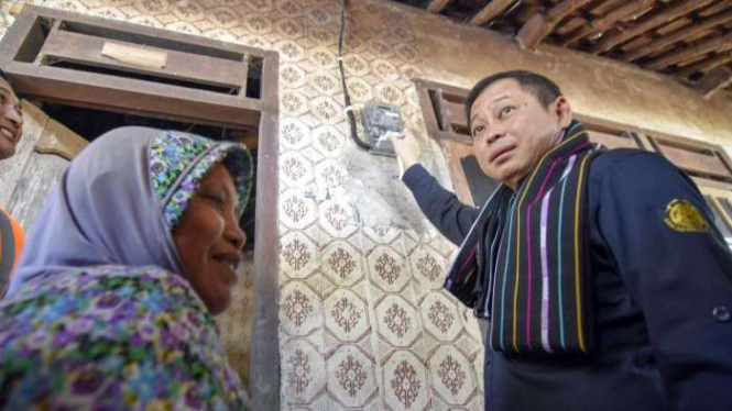 Menteri Energi dan Sumber Daya Mineral (ESDM) Ignasius Jonan (kanan) mengaktifkan sakelar meteran listrik saat meresmikan Bantuan Pasang Baru Listrik gratis di Dusun Bunceman, Desa Gemel, Kecamatan Jonggat, Praya, Lombok Tengah, NTB. 