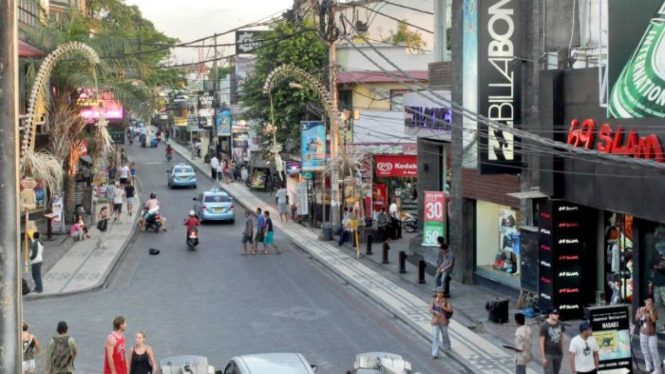 Traffic passes along Legian Street in Kuta, Bali.