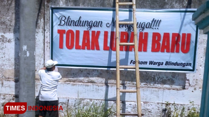 Pemasangan spanduk oleh warga Blindungan Kecamatan Bondowoso. (FOTO: Moh Bahri/TIMES Indonesia)