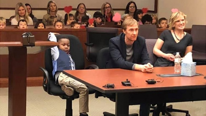 The little boy, identified as Michael, was cheered on by his friends as he was formally adopted - Kent County court